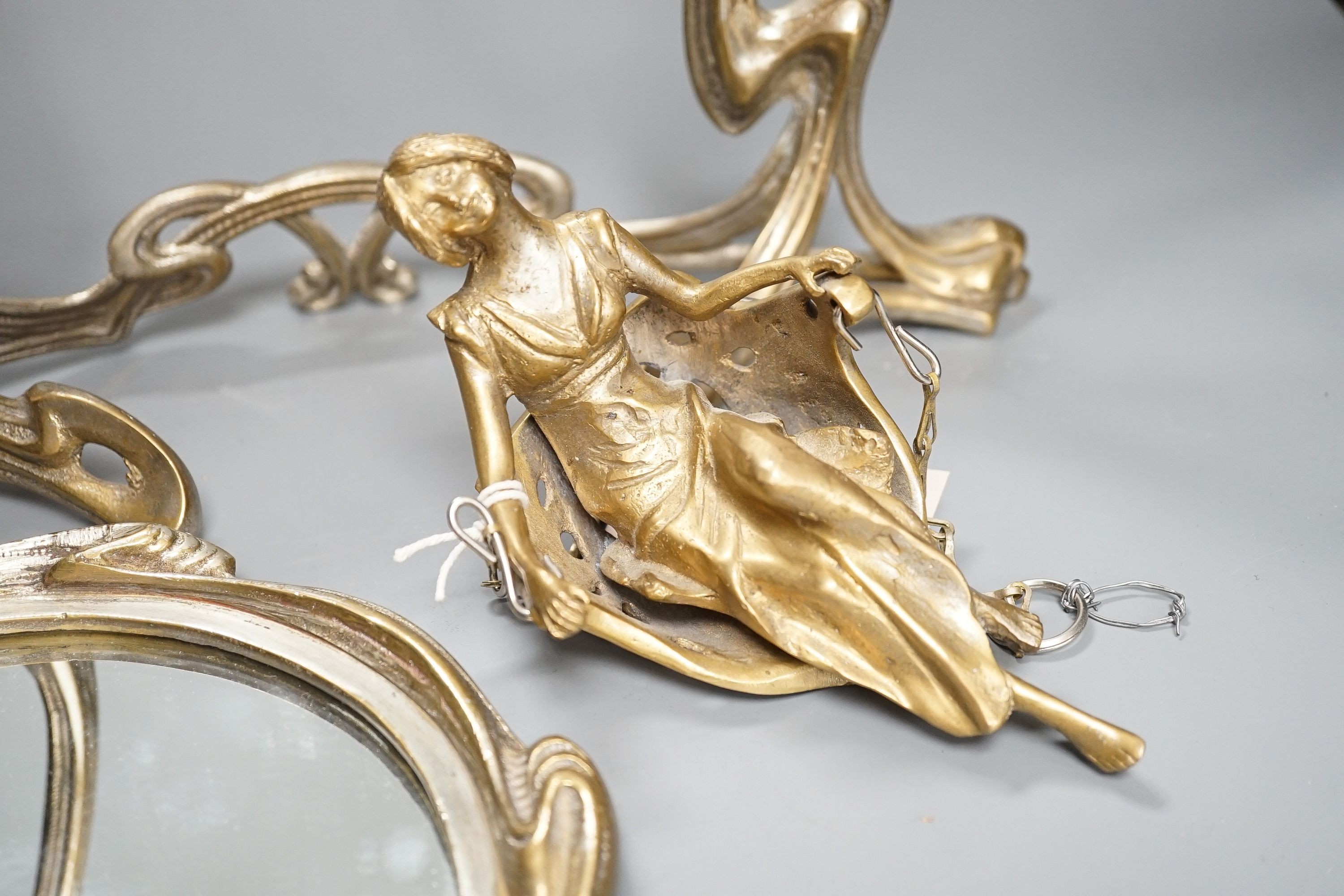 An Art Nouveau style mirror with model of girl sitting on a swing, height 45cm